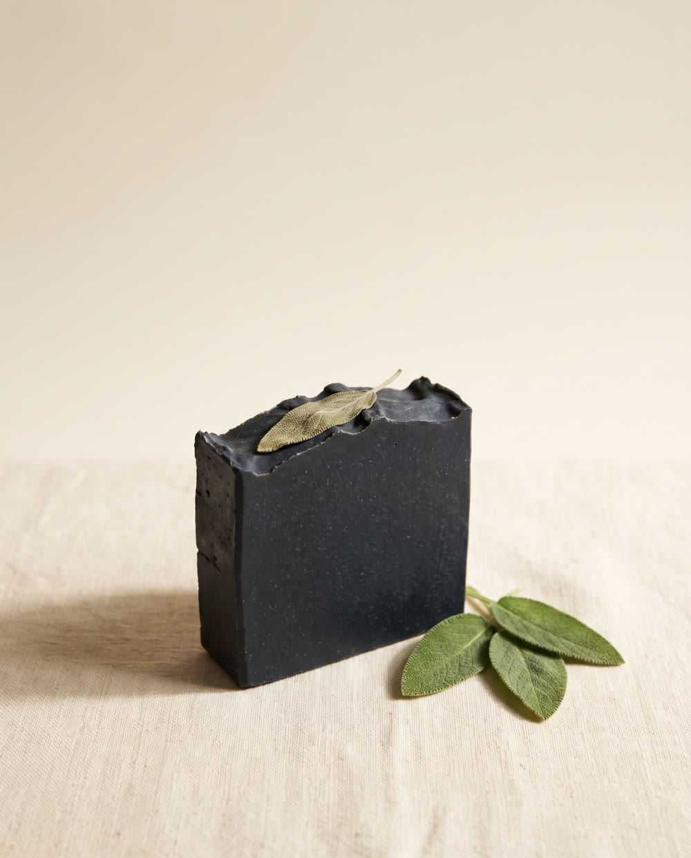 Charcoal and Sage bar, deep black with a pressed sage leaf